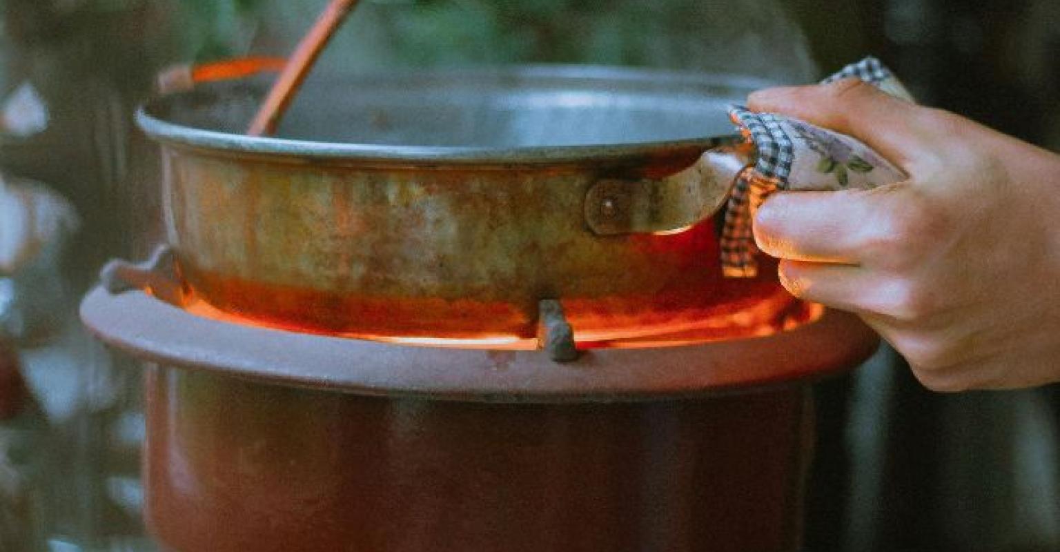 hands stirring sauce in a saucepan