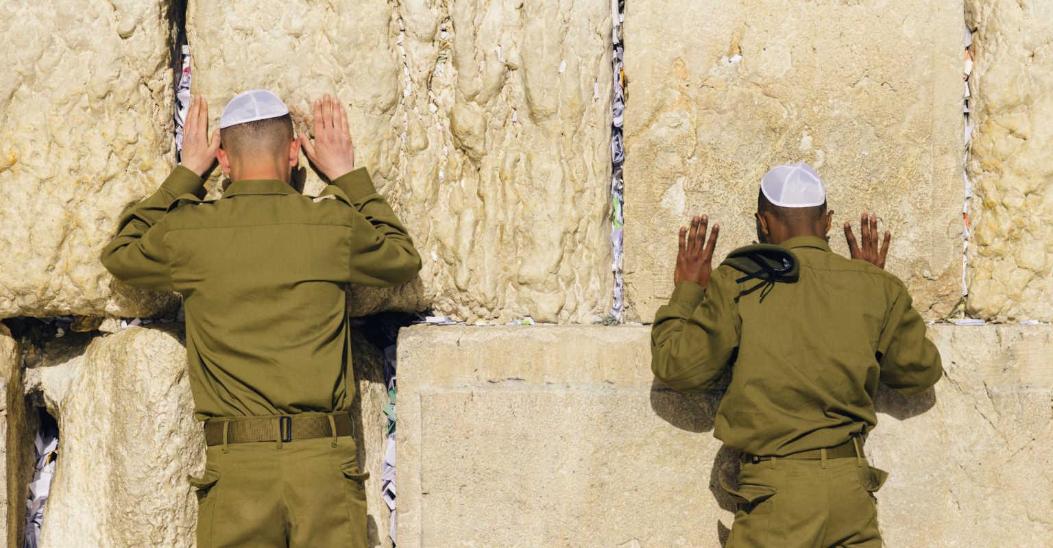Two Israeli soldiers pray at the Western Wall