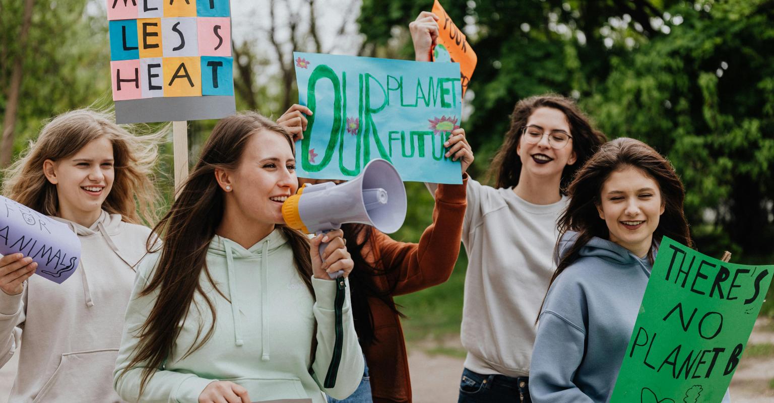 Smiling teens holding signs