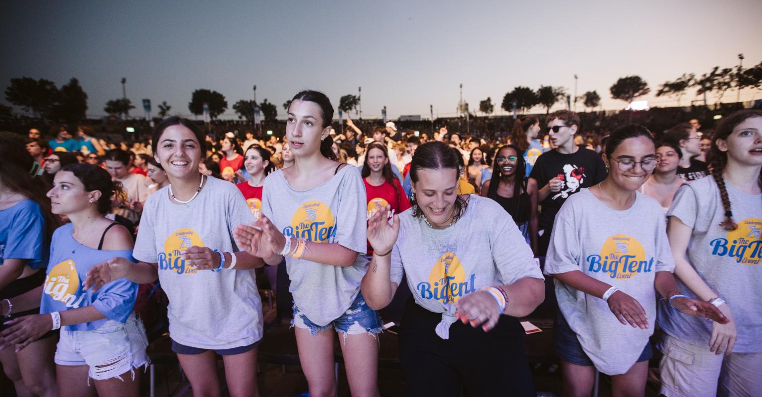 Group of teens in "Big Tent" shirts dancing