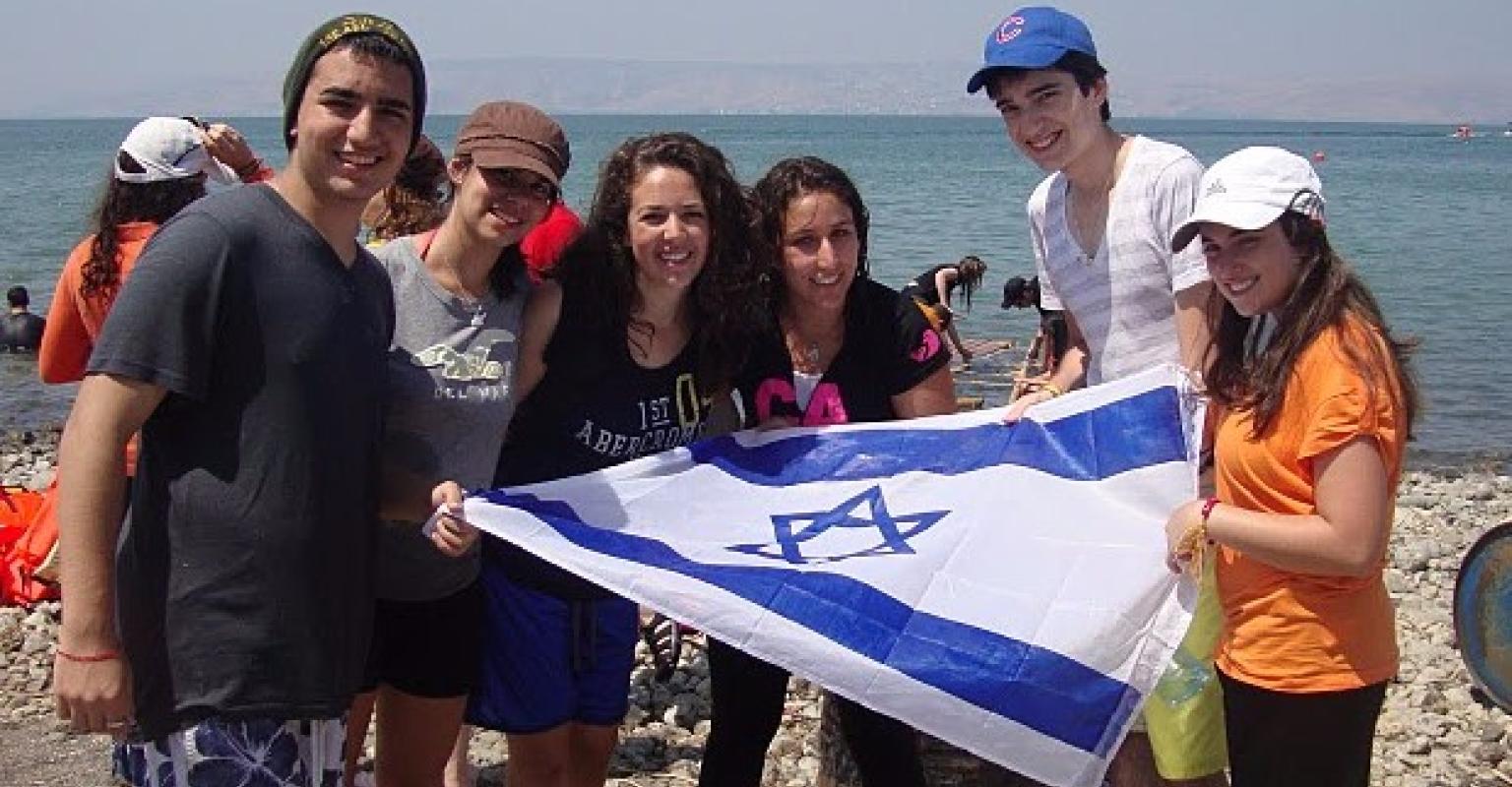 Teens holding Israeli flag