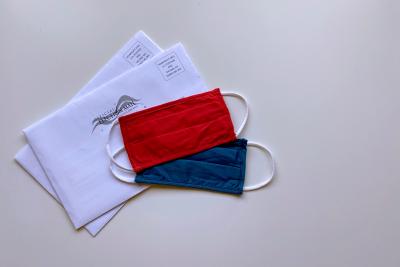 Civic and Civil Engagement image with a blue and red mask and absentee ballot envelopes