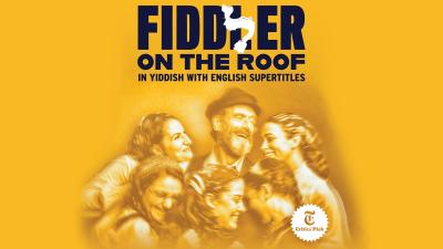 The text Fiddler on the Roof in Yiddish with characters, a family huddled around each other smiling