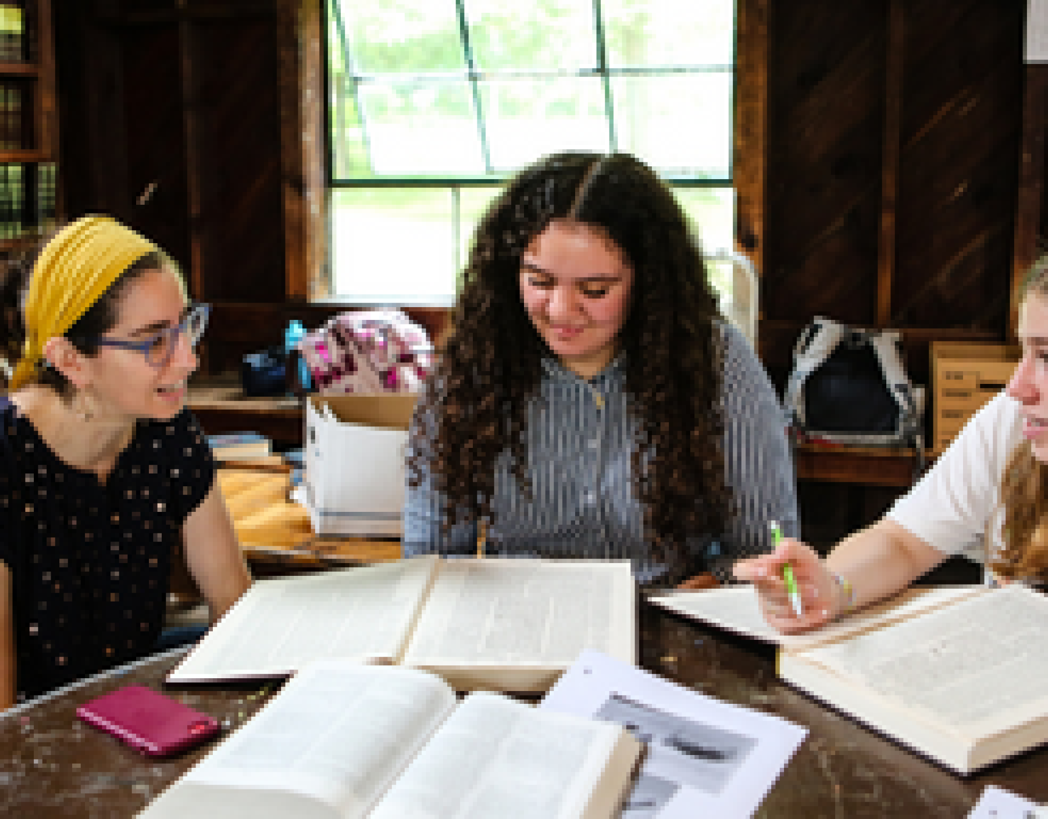 Women study Jewish text together inside