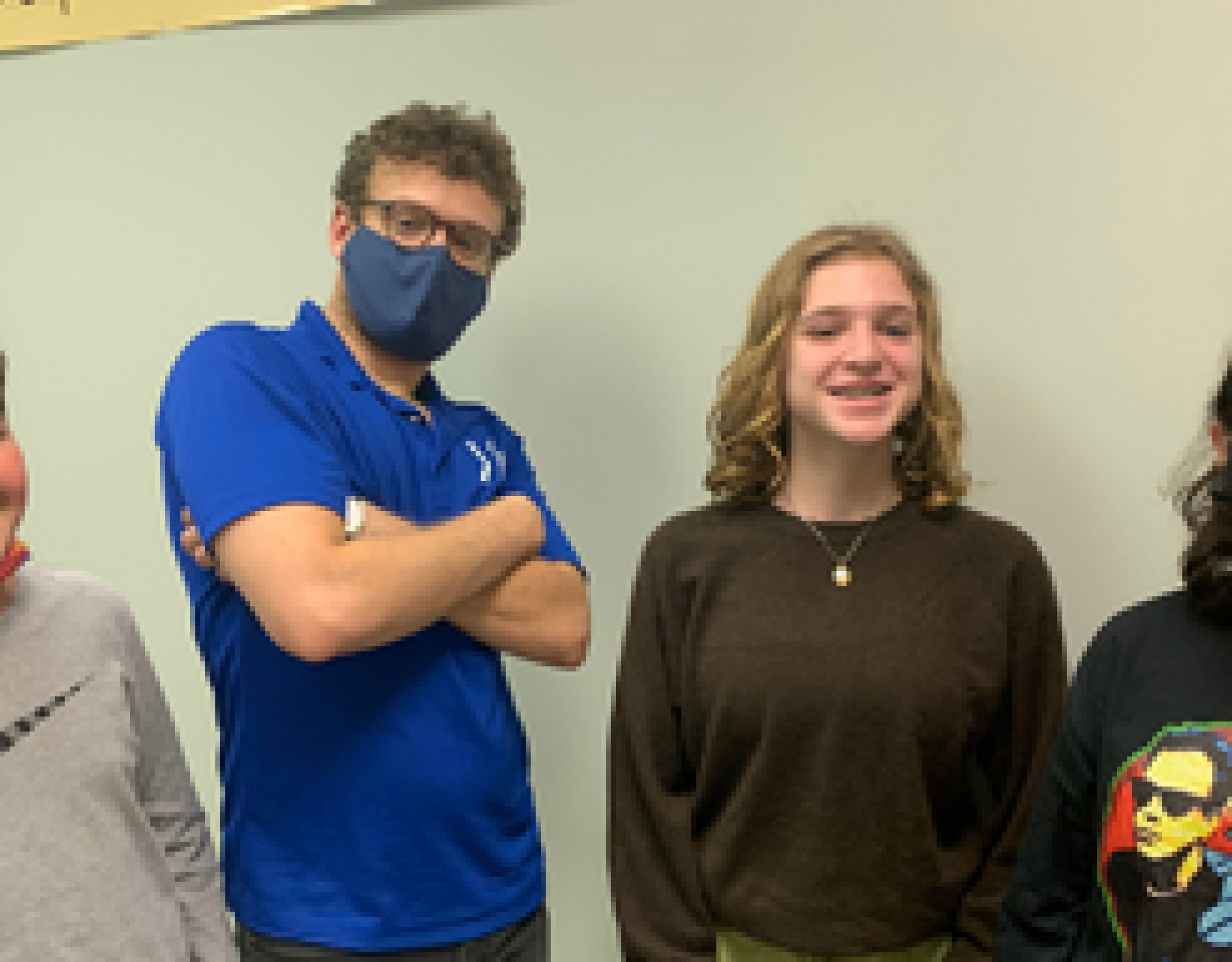 A teacher stands with his students