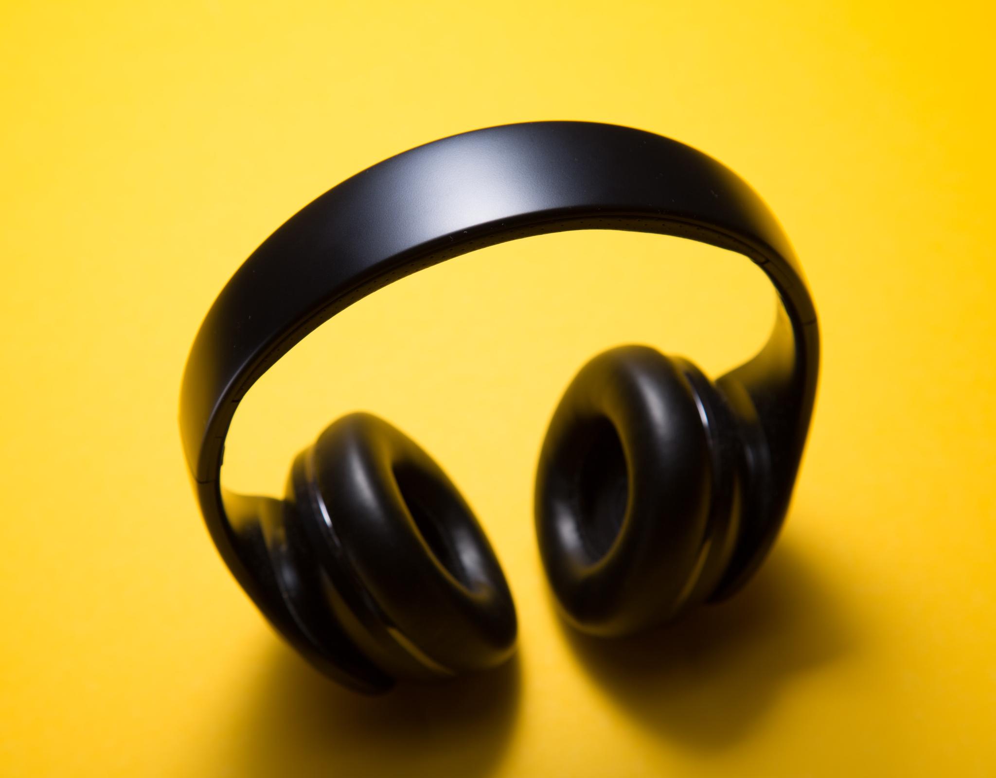 Black earphones on a yellow background