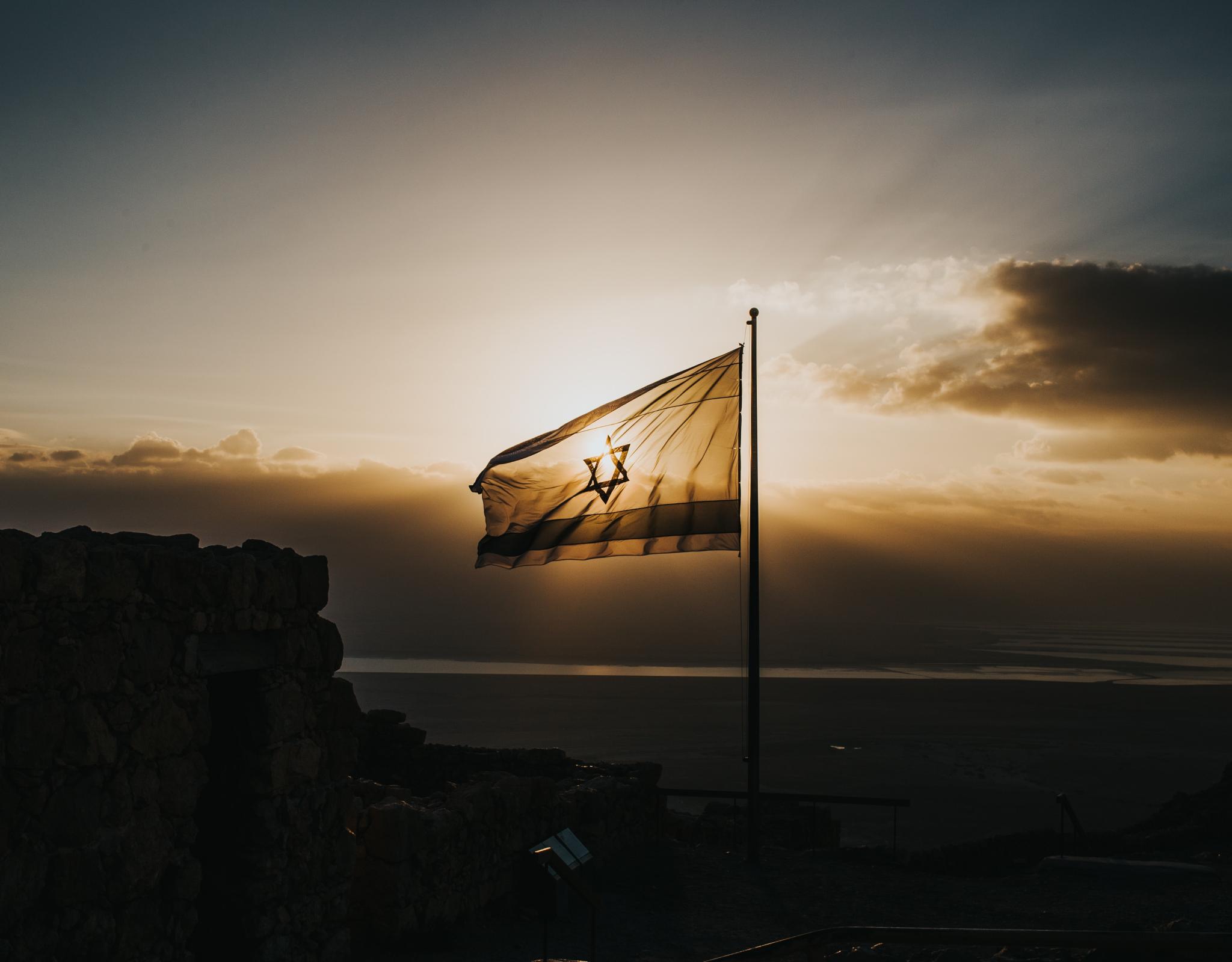 Israeli flag waving in sunset