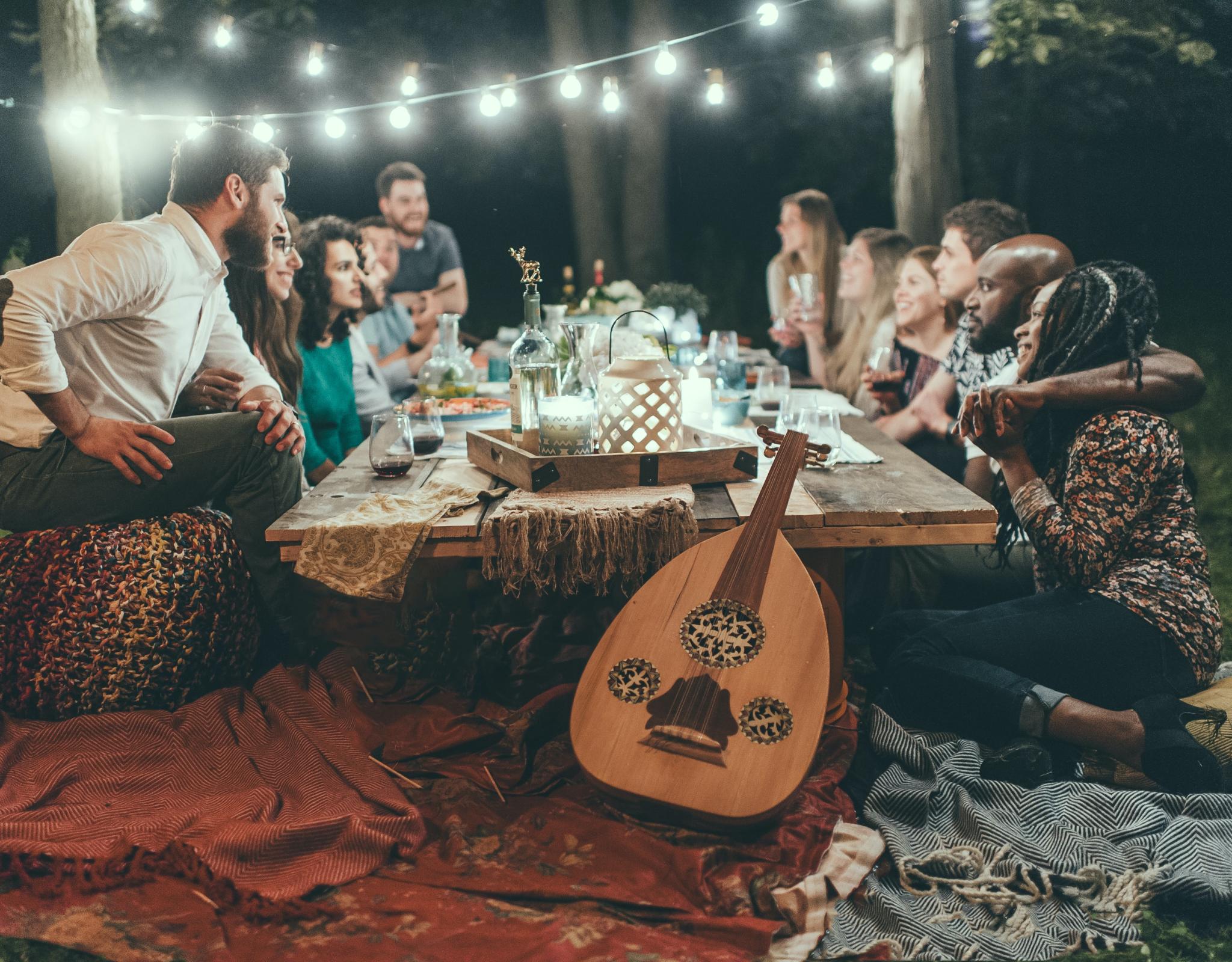 People around a table with candles