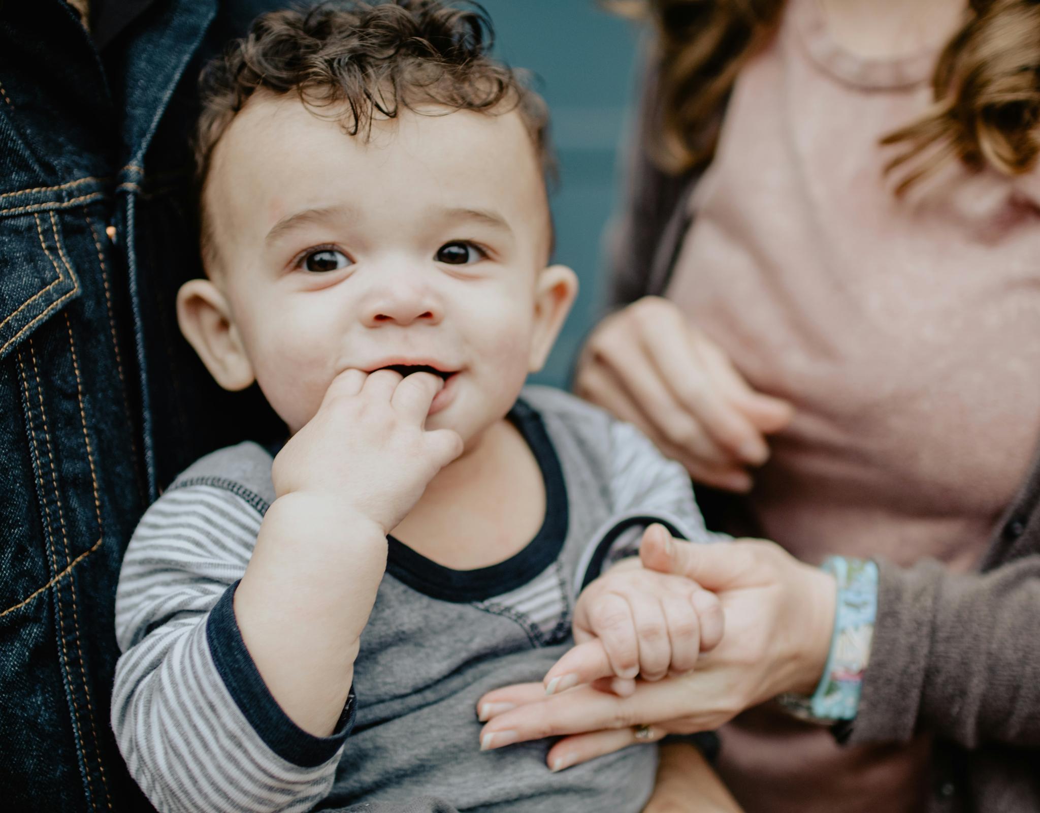 Baby held by parents