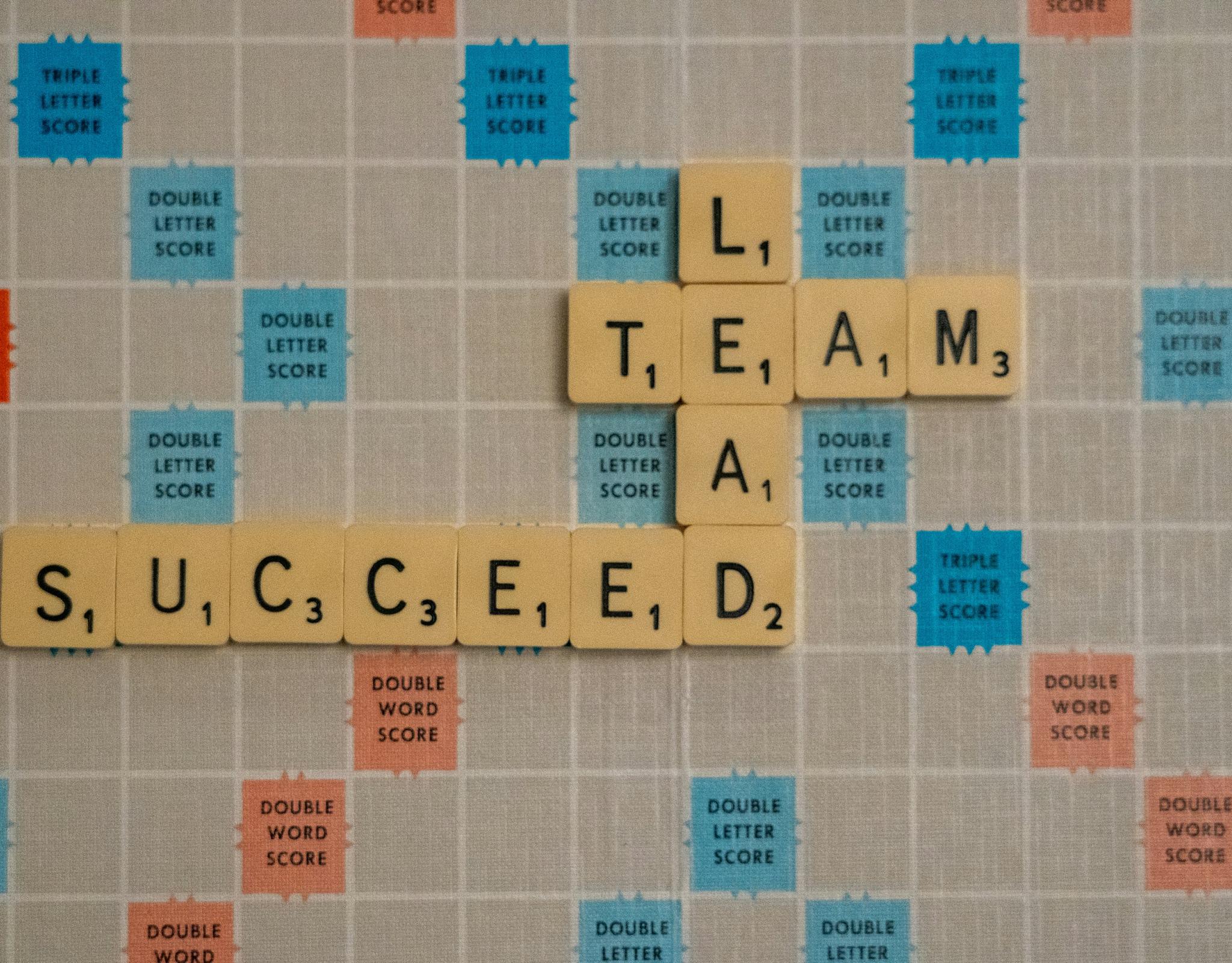 Scrabble board with lead, team, succeed tiles