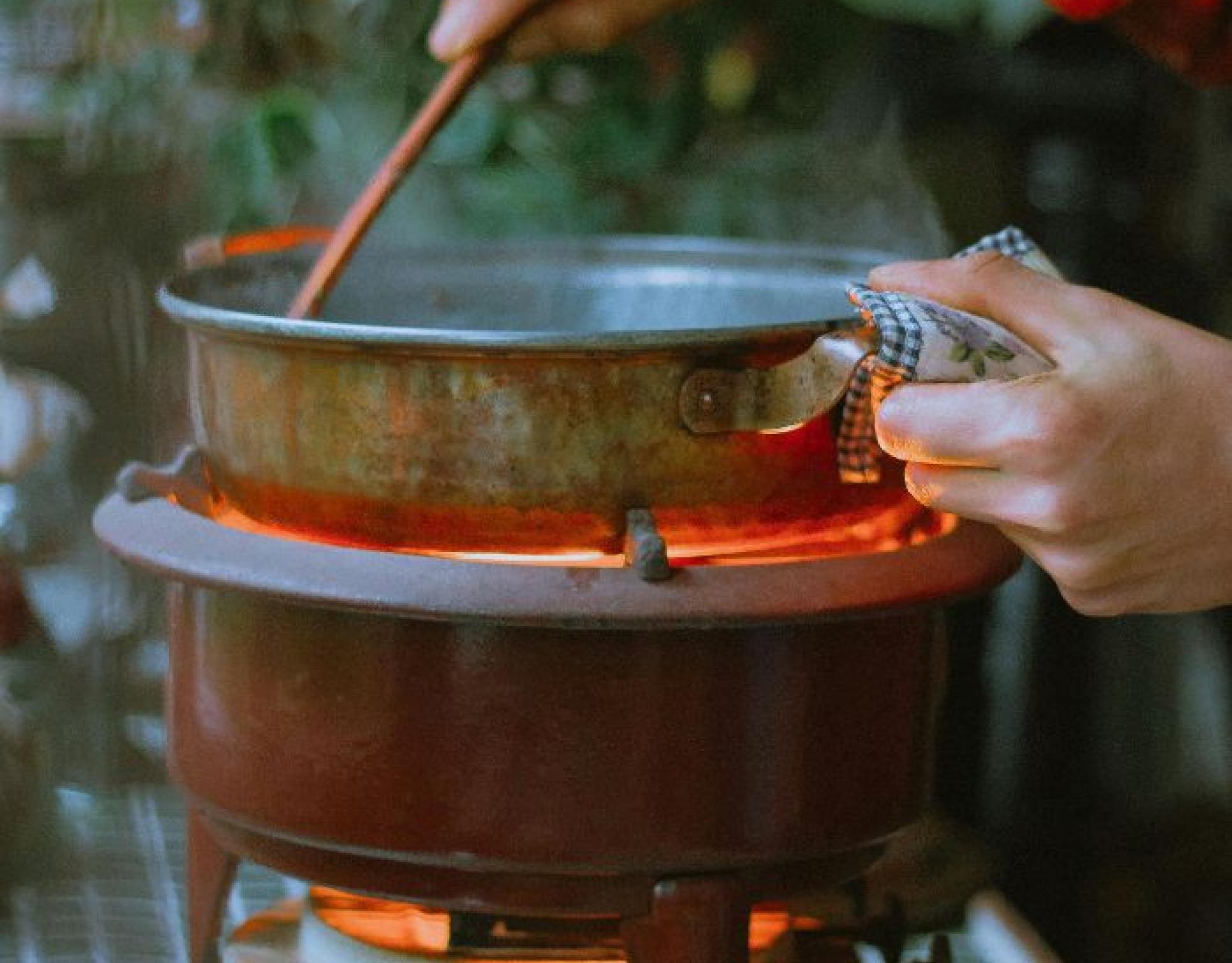 hands stirring sauce in a saucepan