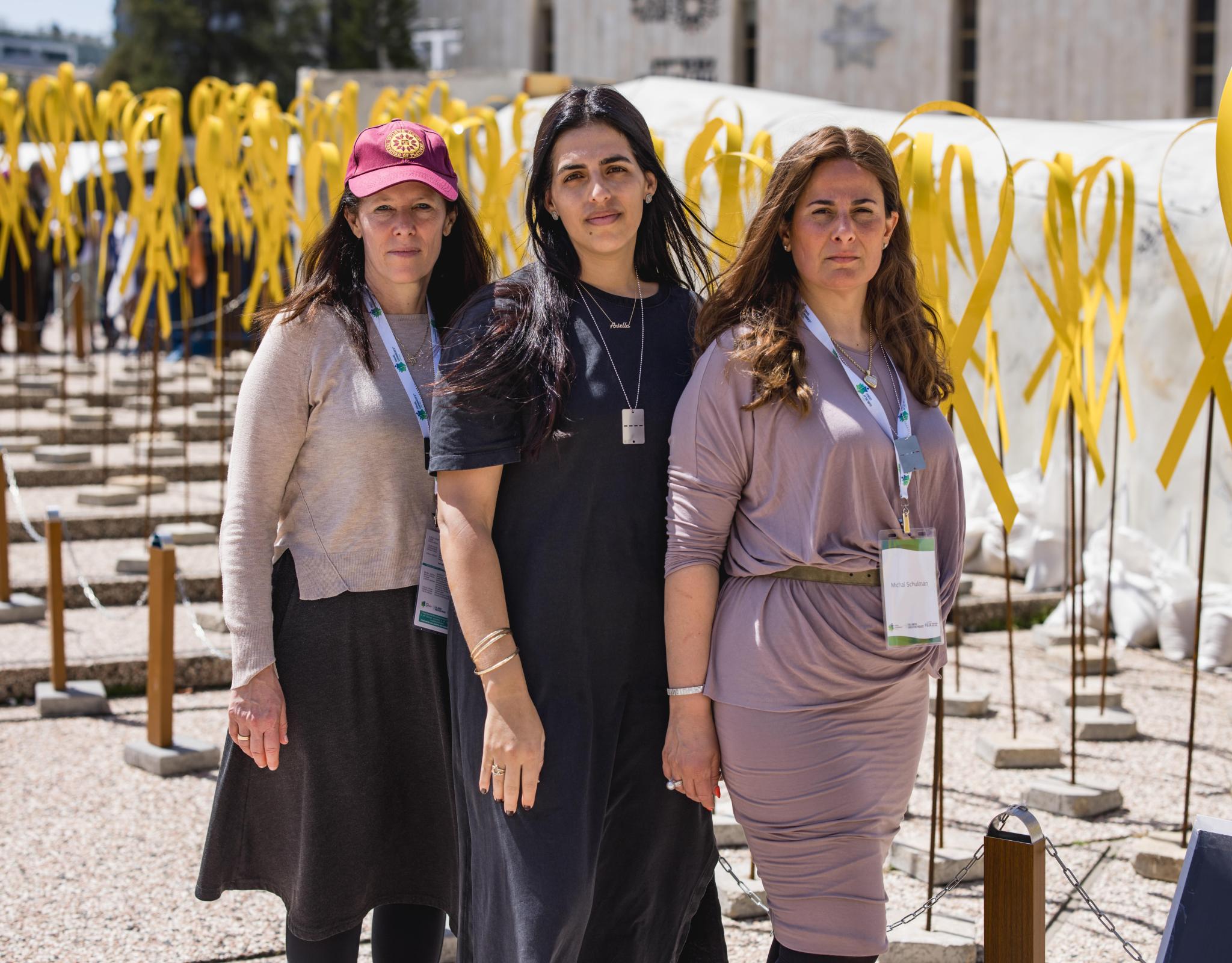 three women in hostage square look at the camera