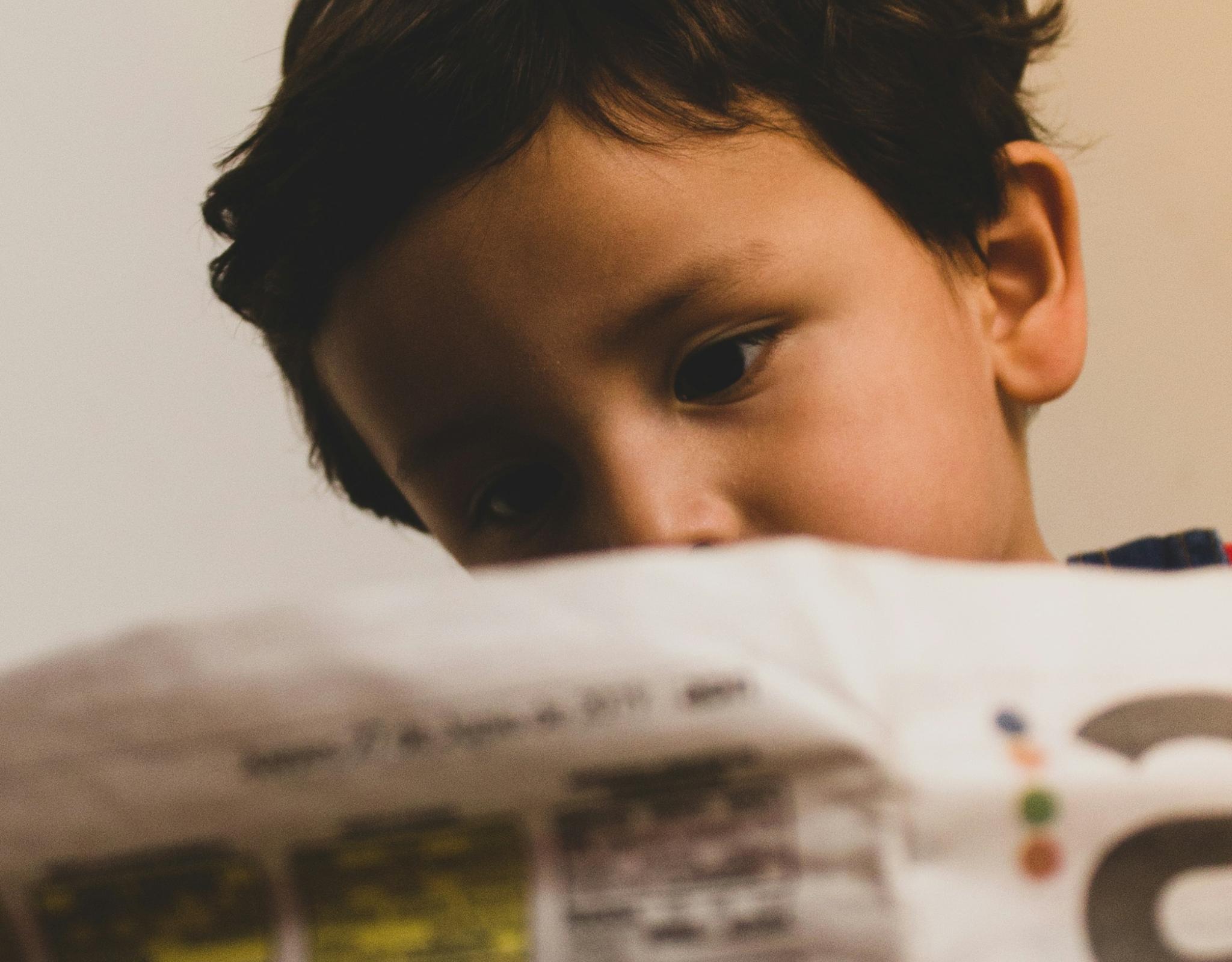 child reading newspaper