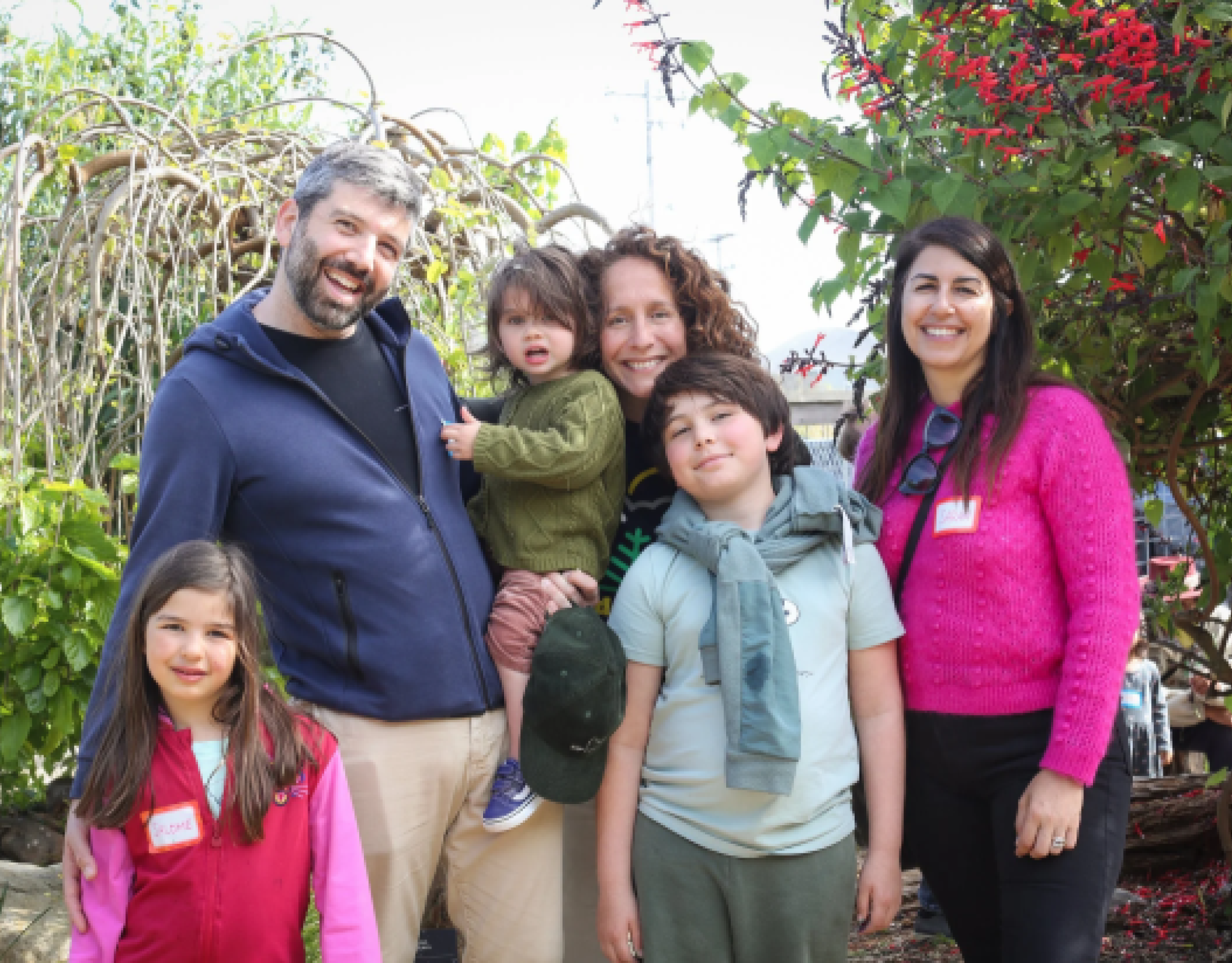 one man, two women, and three children smile at the camera