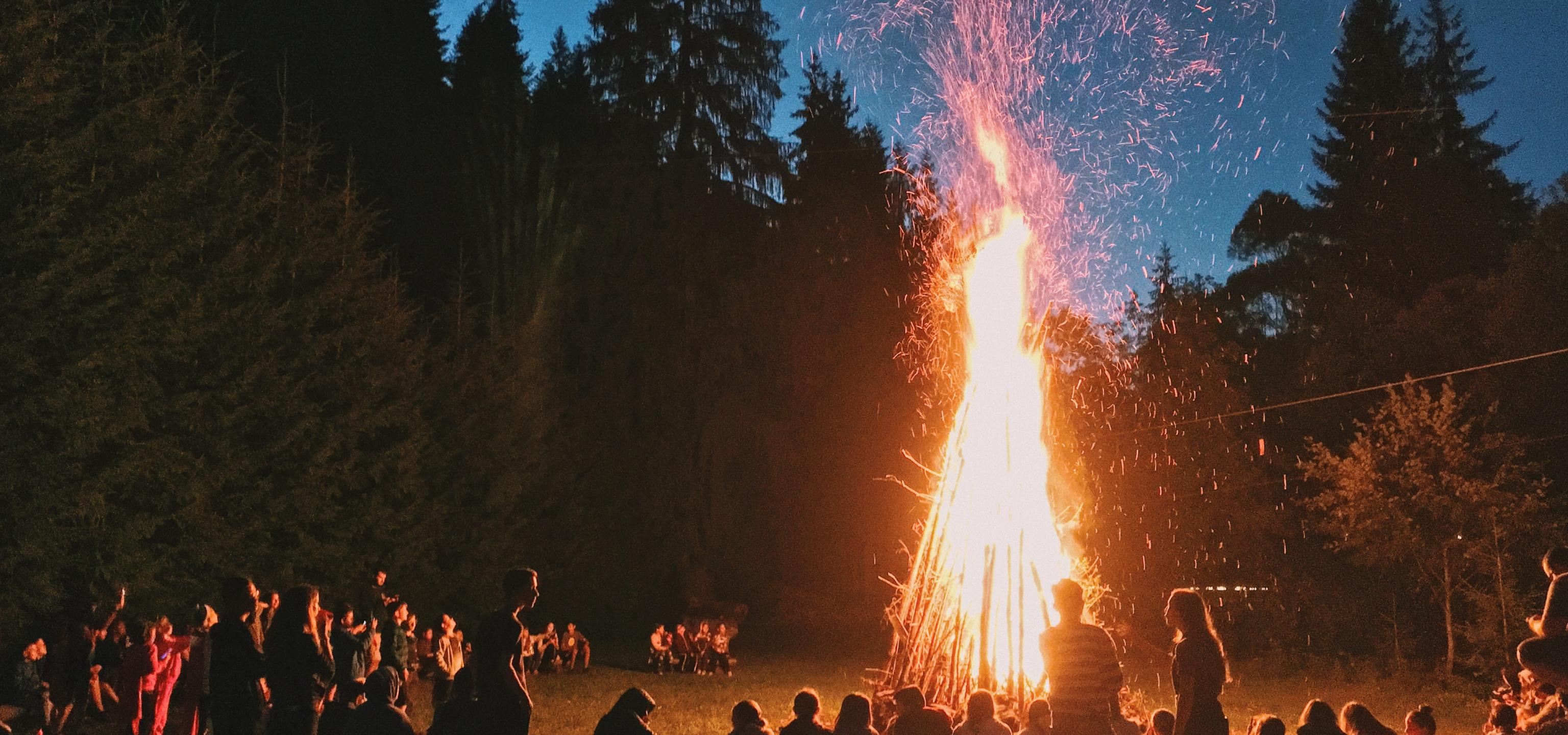 A bonfire with people gathered around