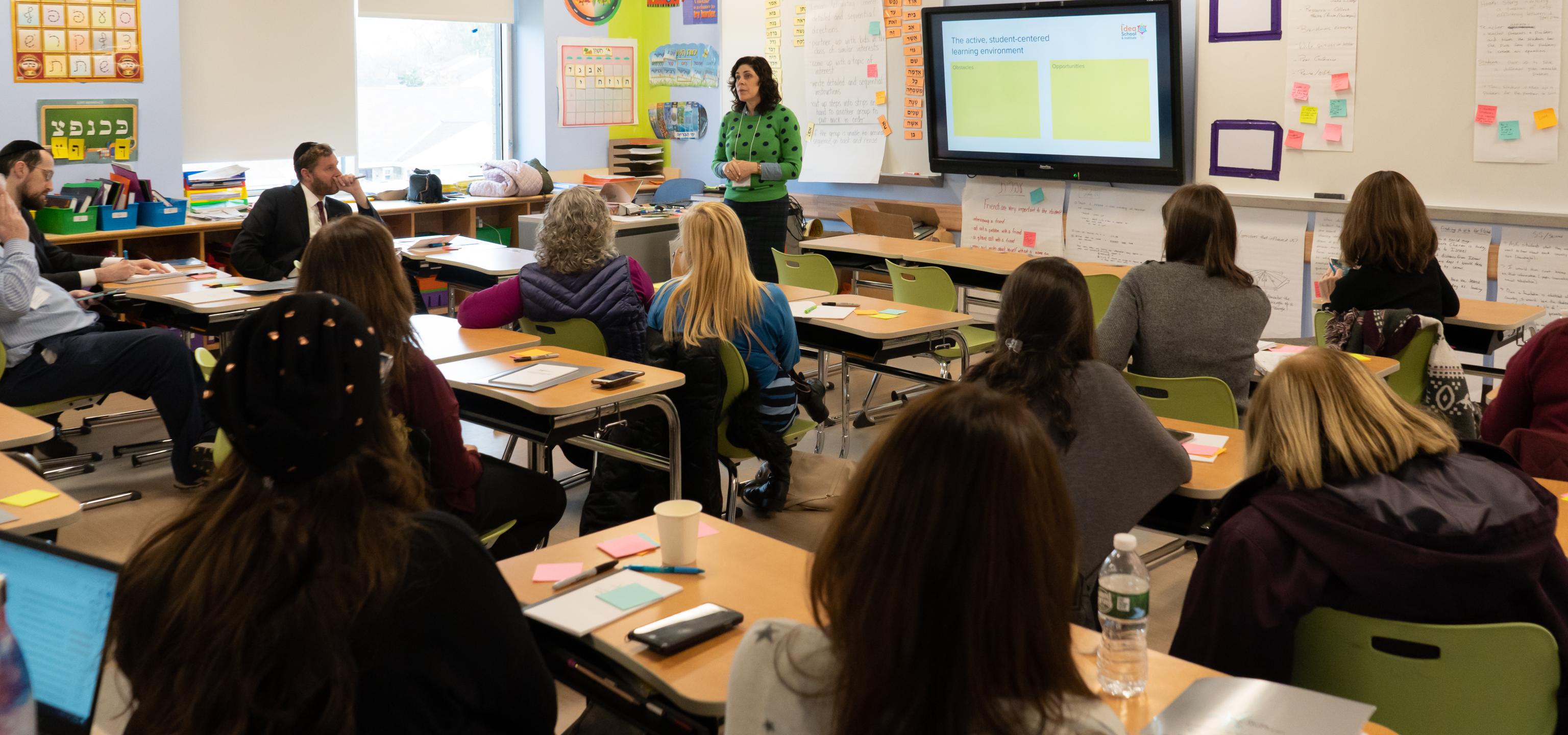 woman teaching full class of adult learners