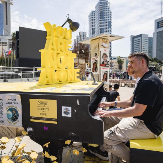 Person playing the piano at Hostage Square