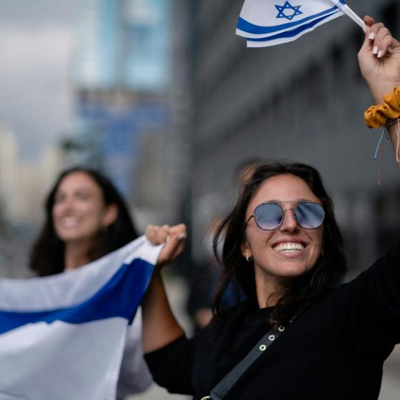 Women holding Israeli flag and celebrating 