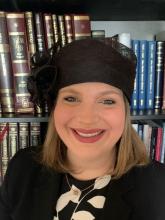 Rabba Yaffa Epstein pictured in front of a bookshelf 