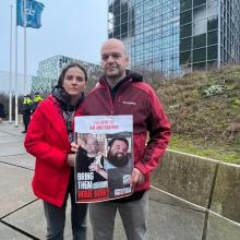 Dalia and her husband holding a hostage poster for her brothers-in-law in front of the UN building