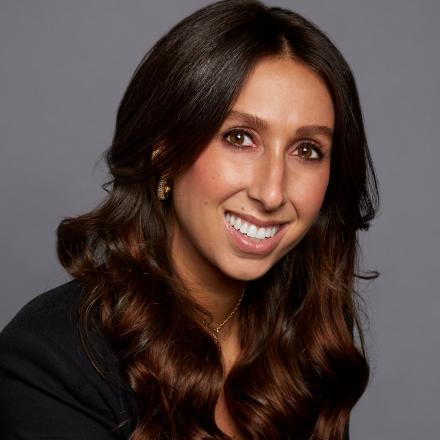 Amanda Berman in front of a grey background.