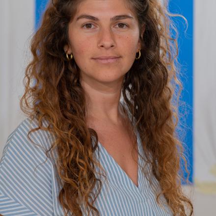 A headshot of Lior, standing in front of an Israeli flag