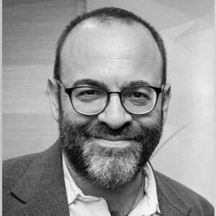 A black and white headshot of Yakir Englander