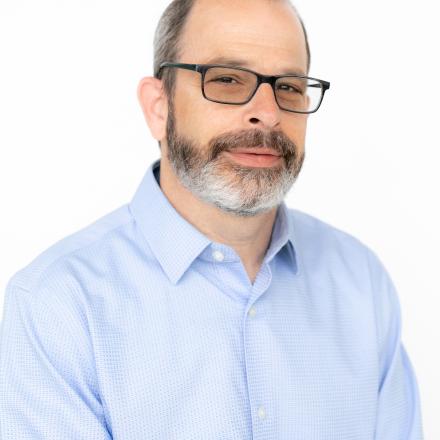 A headshot of Michael in front of a white background.